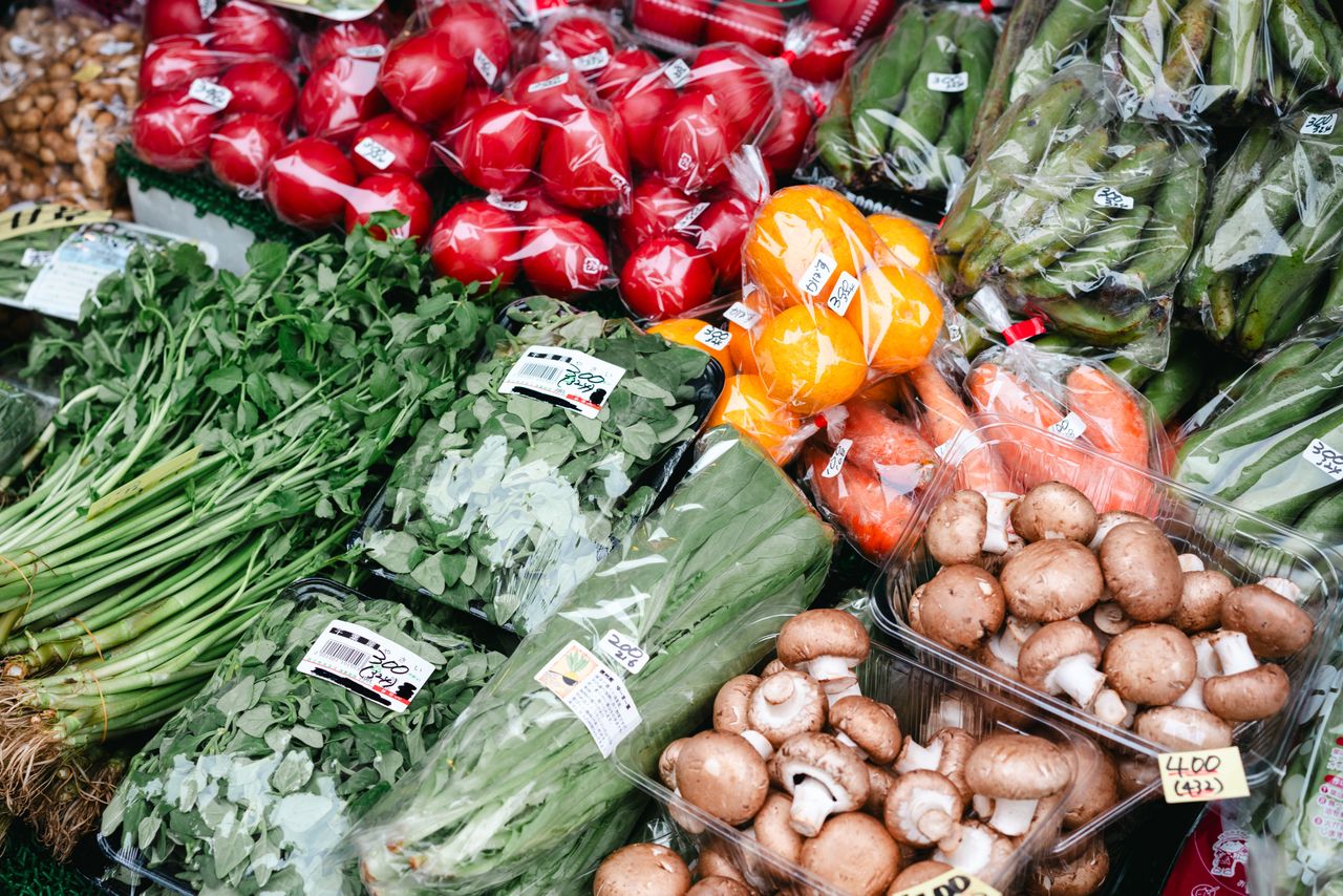 Fresh organic vegetables displayed at Tokyo farmers market, showcasing agricultural diversity.