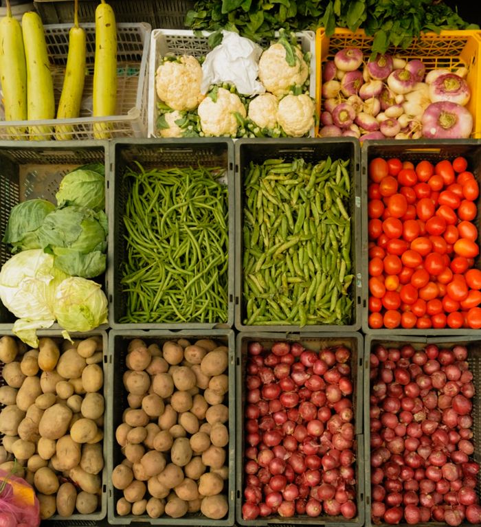 Colorful assortment of vegetables in baskets at a local farmer's market.